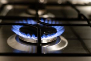 A detailed view of a blue flame on a stove, showcasing energy and heat.